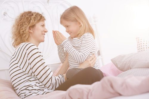 Mother and daughter on a bed